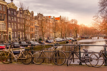 Amsterdam canal and bikes during a sunset