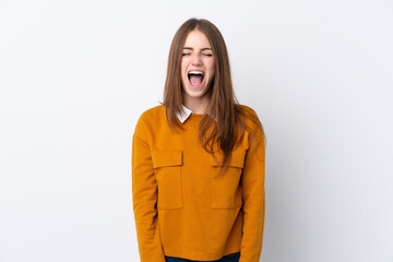 Young woman over isolated white background shouting to the front with mouth wide open