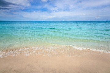 Fototapeta na wymiar Seascape bright sand beach and blue sky