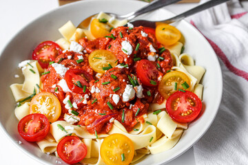 Meatball pasta with cherry tomatoes. Fresh beautiful pasta dish. White background. 
