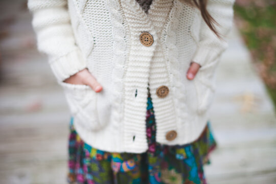 Close up of girl wearing cozy white cable knit sweater