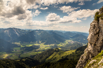 Obraz na płótnie Canvas Hiking from the mountain station to the top of the mountain called Wendelstein in Bavaria, Germany at a cloudy day in summer. Beautiful panoramic view.