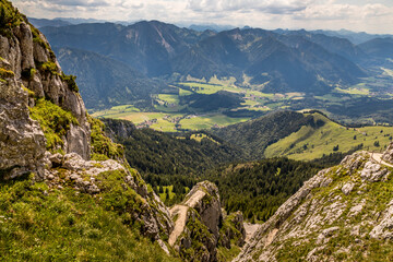 Hiking from the mountain station to the top of the mountain called Wendelstein in Bavaria, Germany at a cloudy day in summer. Beautiful panoramic view.