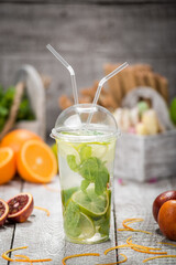 Mojito cocktail in a bur on rustic table