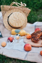 Things for a picnic. Straw hat and bag, Peach, book, veil, juice. It's a good time.