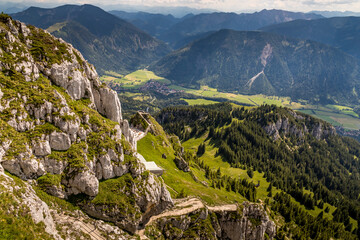 Hiking from the mountain station to the top of the mountain called Wendelstein in Bavaria, Germany at a cloudy day in summer. Beautiful panoramic view.