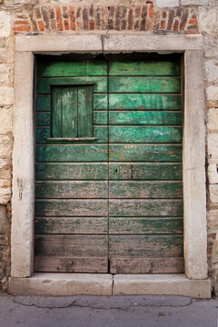 A scarred green door.