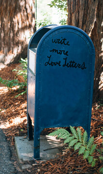 Large blue mailbox that says Write more Love Letters on the side