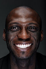 Portrait of handsome happy smiling black afro-american man with white teeth close-up face head-shot