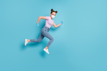 Fototapeta na wymiar Full length body size view of her she attractive motivated girl youth teenage wearing n95 mask jumping running mers cov prevention healthcare isolated blue pastel color background