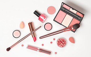 Beauty cosmetics makeup product flying. Woman make up, brushes lipstick and blossom falling in...