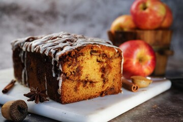 Homemade Apple Fritter Bread drizzled with white glaze on fall autumn background, selective focus