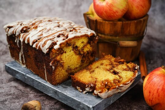 Homemade Apple Fritter Bread drizzled with white glaze on fall autumn background, selective focus