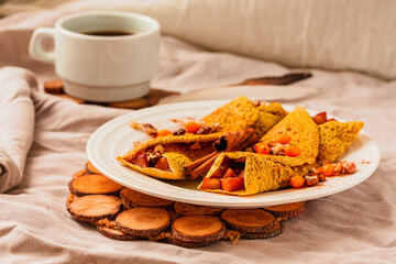 Gluten-free keto Crepes filled with pear, walnut and cinnamon in the oven with sea buckthorns on top. Autumn vegetarian breakfast or healthy dessert concept