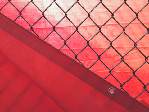 Chain-link fence and red tarp