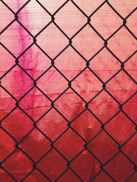 Chain-link fence and red tarp