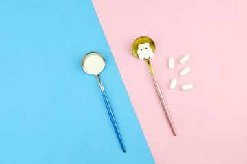 Collagen protein powder and pills in spoons on color background. Dietary supplement for skin and joints