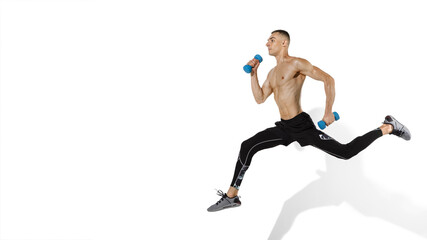 Running, jumping. Stylish young male athlete on white studio background, portrait with shadows. Sportive fit model in motion and action. Body building, healthy lifestyle, style concept. Flyer