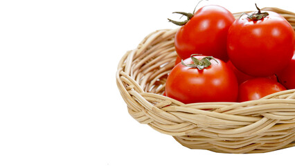 Red tomato in a bamboo basket on isolated background