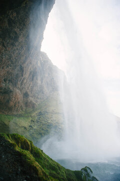 Standing behind a Seljalandsfoss waterfall in Iceland