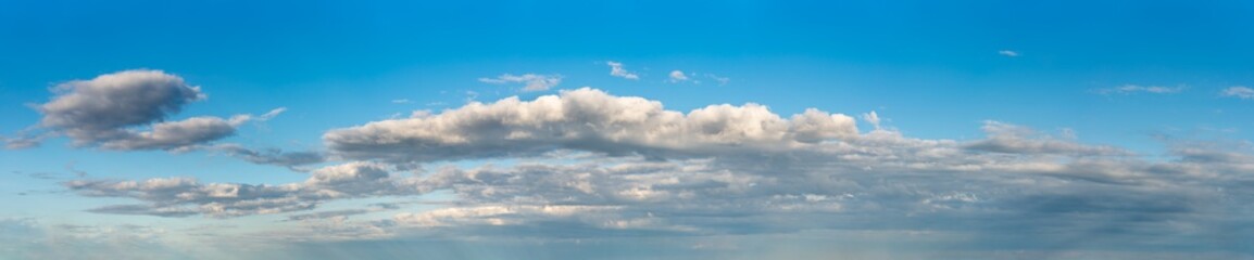 Fantastic clouds against blue sky, panorama