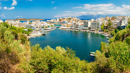Fototapeta na wymiar Agios Nikolaos, Greece - August 9, 2020 - View of the bay of Agios Nikolaos with the famous port