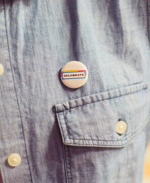 A celebration button worn on a shirt