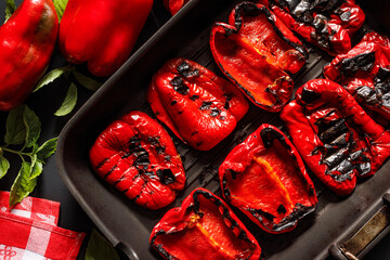 Grilled red peppers on a grill plate close up view