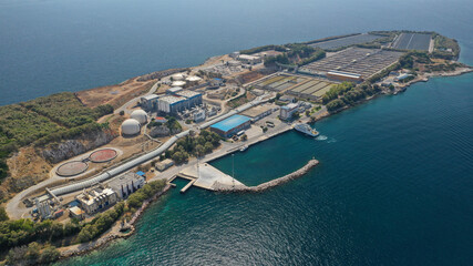 Aerial drone photo of small island of Psitaleia, a latest technology industrial sewage plant near...