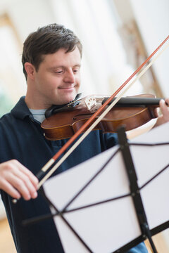 Man with down syndrome playing violin