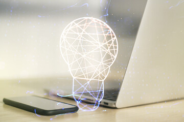 Fototapeta na wymiar Creative light bulb hologram on modern laptop background, idea concept. Multiexposure