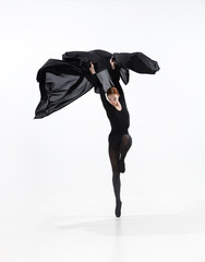 Elegance. Young and graceful ballet dancer in minimal black style isolated on white studio...