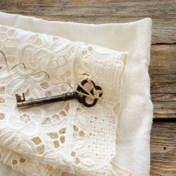 Studio shot of antique key on lace cloth