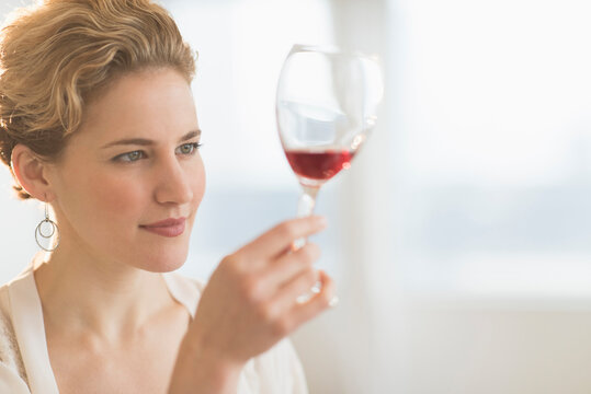 Young Woman Examining Red Wine