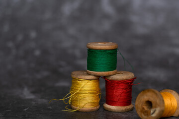 Different colorful cotton mill on grey background