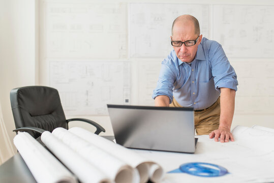 Mature architect using laptop in office