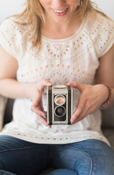 Woman using antique camera