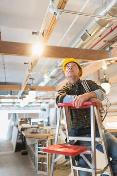Electrician standing on step ladder