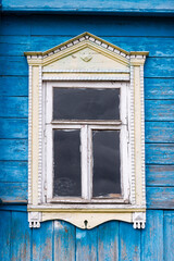 Gingerbread wood trims. Simple decorated window of an old wooden house