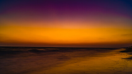 Naklejka na ściany i meble view from the beach on the setting sun