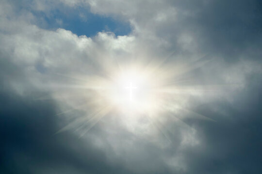 Glowing cross sign in clouds
