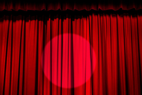 Spotlight on red curtain
