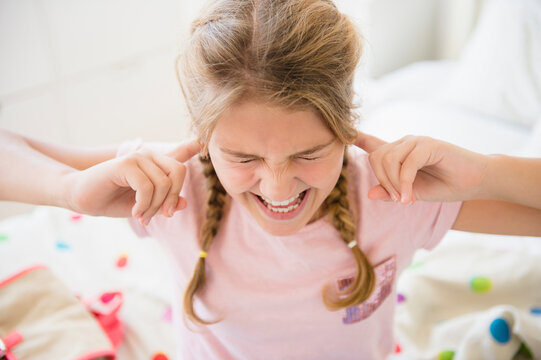Angry girl (12-13) in bedroom