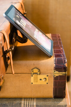 Studio shot of digital tablet on suitcases