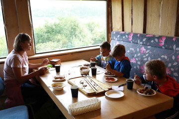 Mother with sons have lunch