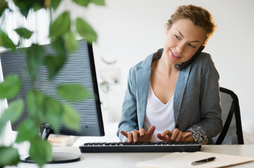 Young businesswoman working on desktop computer in office