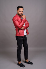 Fototapeta premium Young bearded Indian man against gray background