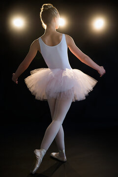 Fototapeta Rear view of teenage (16-17) ballerina on stage