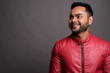 Fototapeta premium Young bearded Indian man against gray background