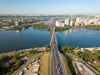 Obraz premium Aerial drone view. Automobile North Bridge in Kiev across the Dnieper River. Sunny day.